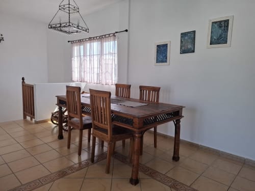 Wooden dining table with chairs in bright villa dining room, Puerto Calero, Las Palmas