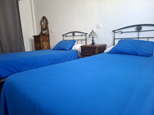 Twin beds with bright blue bedding in Villa 8 at Villas del Mar, Puerto Calero, Las Palmas