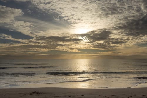 Sunrise over ocean beach near Le Prieuré Notre-Dame, Montfrin France
