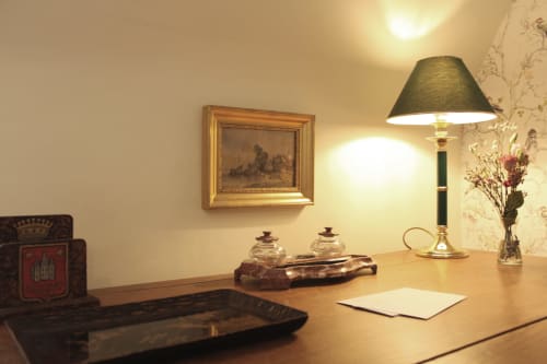 Elegant desk in La Suite de la Tour at Domaine de Bort near Limoges, featuring lamp, writing paper, and period decor