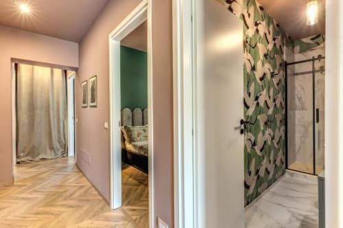 Corridoio moderno con carta da parati floreale, doccia in marmo e pavimento in legno nella suite Cinque Terre Swing di Downtown Srl