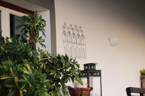 Cozy Monte da Morena guesthouse room with potted plant, wire wall art, and black lantern decor in Serpa, Portugal