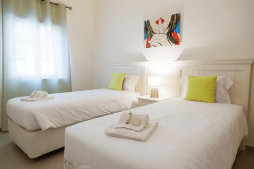 Twin beds with lime pillows in modern Be SilverCoast hotel room, Serra D'El Rei Portugal