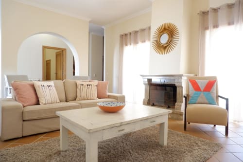Bright living room at Be SilverCoast with beige sofa, fireplace, and modern décor in Serra D'El Rei
