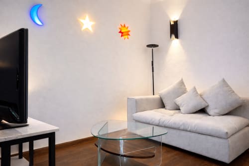 Modern bedroom at Villa Merida Boutique Hotel with TV, comfortable seating, and decorative neon lighting in Merida, MX