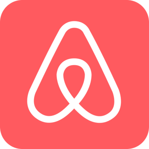 Logotipo de Airbnb - icono de corazón blanco sobre fondo coral para gestor de propiedades Tr3sor en España