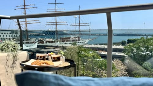 Terrazza dell'appartamento di Palermo con vista mare, velieri e porto, allestimento per cena esterna