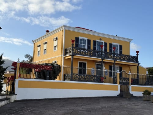 Golden Mermaid Villa, a charming yellow and white Portuguese bed and breakfast with ornate balconies