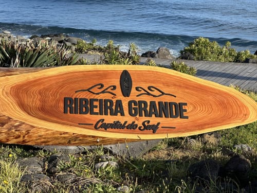 Ribeira Grande surf sign with ocean waves and coastal vegetation in Portugal