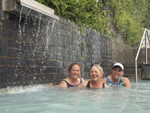Three women enjoying a hot spring bath at Golden Mermaid Villa, Portugal