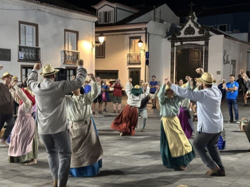 Traditional Portuguese dance celebration in historic plaza at Golden Mermaid Villa, Portugal