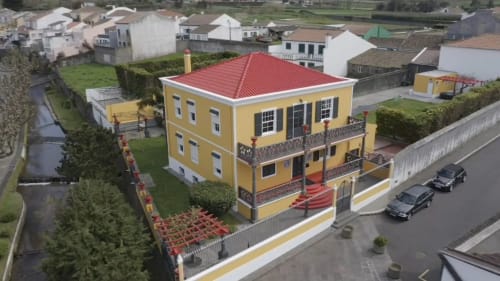 Golden Mermaid Villa B&B in Portugal - yellow mansion with red roof and balconies, aerial view
