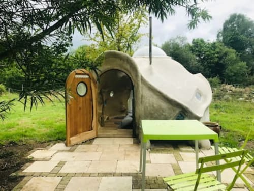 Unique glamping pod accommodation at Le Lama Zébré in Penmarch with wooden entrance door and green seating area