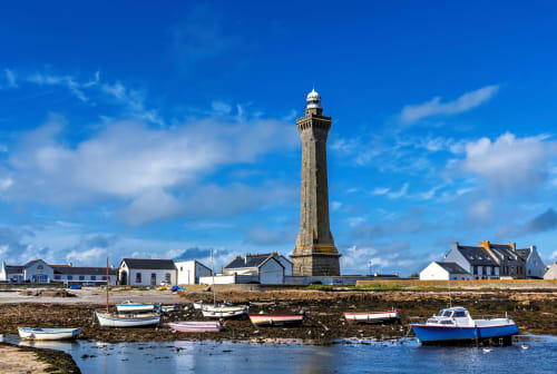 Penmarch lighthouse with colorful fishing boats in harbor, France - Le Lama Zébré BnB location