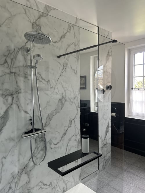 Modern walk-in shower in high-end marble with a rain shower head at Le Clos d'Azel, a guest house in Alsace