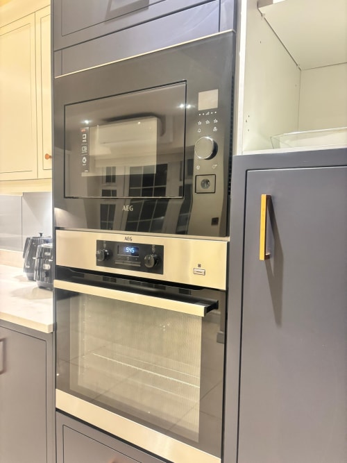 Modern AEG built-in oven and microwave in furnished home kitchen at England Furnished Homes, Egham