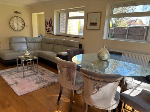 Spacious furnished living room in High Wycombe with leather sofa, dining table, garden view windows, and modern amenities
