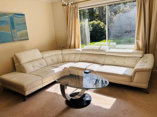 Spacious cream leather sectional sofa in modern living room with garden view at England Furnished Homes