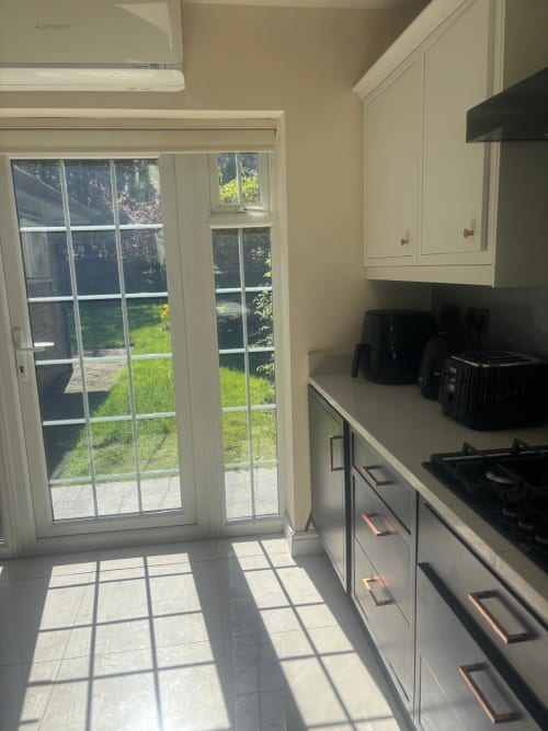 Bright kitchen with garden view through patio doors in furnished home, High Wycombe
