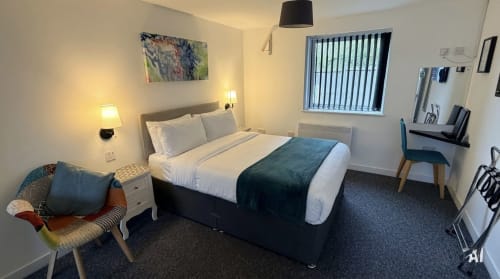 Mayland Motel double room in Essex with queen bed, desk chair, window, and modern amenities including TV and free wifi