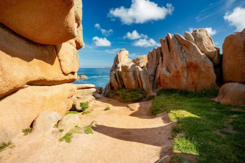 Rocky granite formations and sandy beach cove with ocean view in Trévou-Tréguignec, Brittany