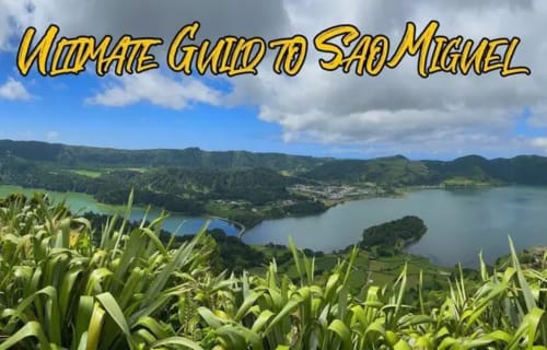 Scenic view of São Miguel's lush green mountains and blue lakes with tropical vegetation in foreground at Golden Mermaid