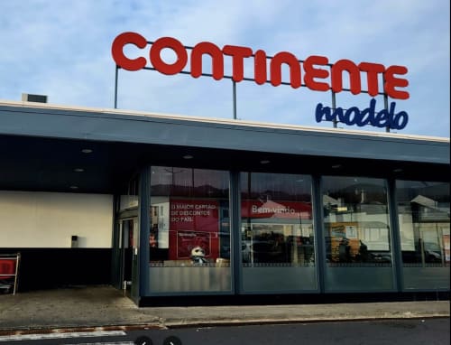 Continente supermarket storefront with red signage and glass windows in Portugal