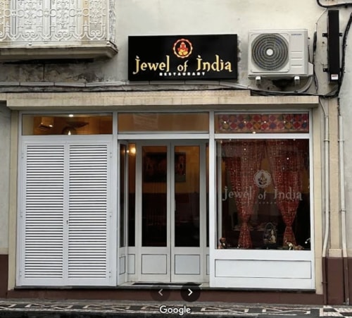 Jewel of India storefront with white doors and ornate architectural details