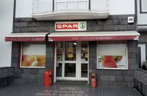 SPAR mini supermarket storefront with red awning and product displays at Golden Mermaid Villa in Portugal