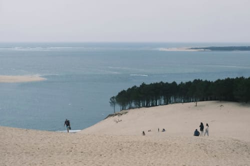 Dune du Pila beach near Arès with sandy slopes, pine forest, and turquoise bay waters