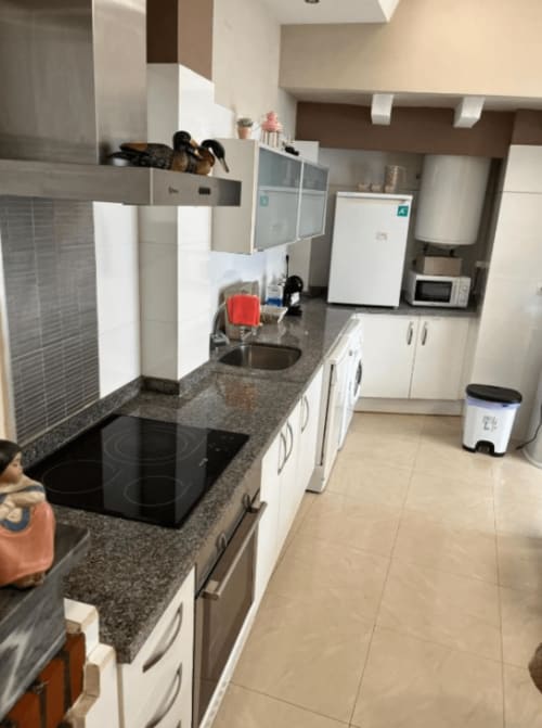 Modern kitchen in Algemesi Home apartment with granite countertops, white cabinetry, electric stove, and stainless steel