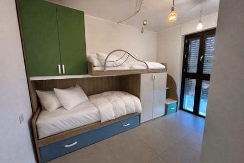 Modern bunk bed bedroom in HB Hall Garden Apartment, Milano with built-in storage and balcony view