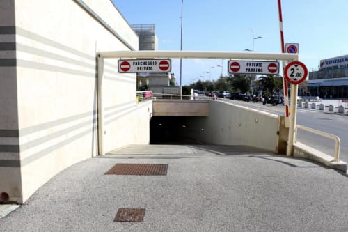 Underground private parking entrance at Versilia Panoramic Luxury hotel in Como, Italy with height restriction sign