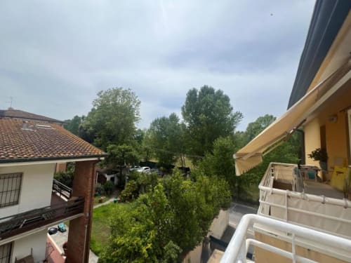 Sofy Penthouse balcony view overlooking lush gardens and neighboring villas in Como, Italy