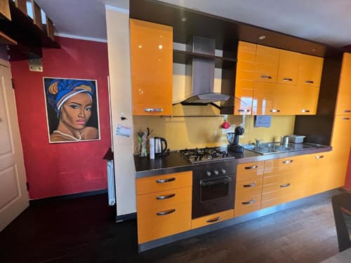 Sofy Penthouse kitchen at Versilia Panoramic Luxury hotel in Como, Italy features vibrant orange cabinetry and modern cooking