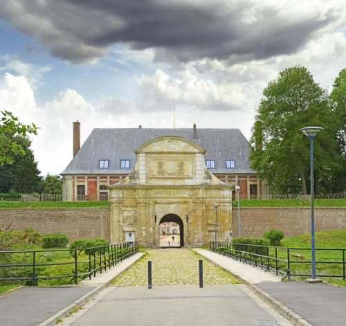 Entrée historique en pierre des Hébergements C&C à Angres, France avec jardins aménagés