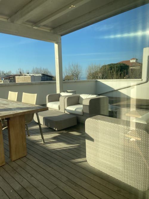 Sunny terrace with wicker seating and sea views at Residence Aida in Rimini, Italy