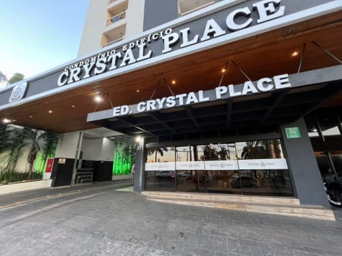 Crystal Place hotel entrance in Goiânia with modern glass facade and covered entrance awning