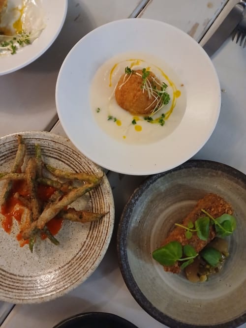Fine dining dishes at Earsham Street House Bungay: plated scallop, crispy toast appetizer, and herb-garnished protein