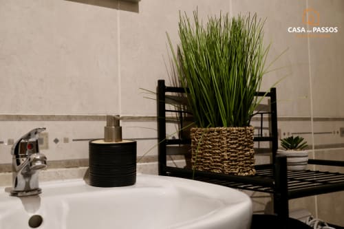 Pia moderna no apartamento Casa Dos Passos em Guarda, decorada com planta em vaso e acessórios decorativos