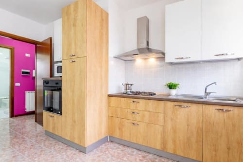 Modern wooden kitchen with stainless steel appliances at Como Holiday apartment, Como, Italy