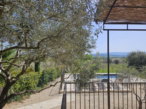 Terrace with olive tree overlooking pool and Provence countryside in Gordes