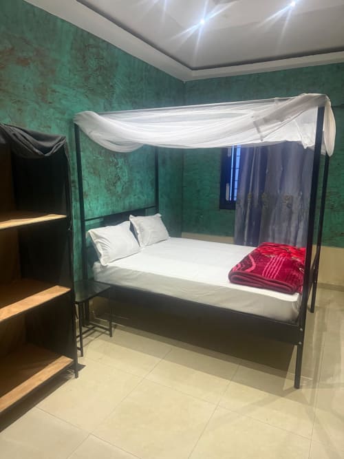 Lit à baldaquin moderne avec draps blancs dans la chambre Kayar de l'hôtel Keur Medzo, Lac Rose, Niaga