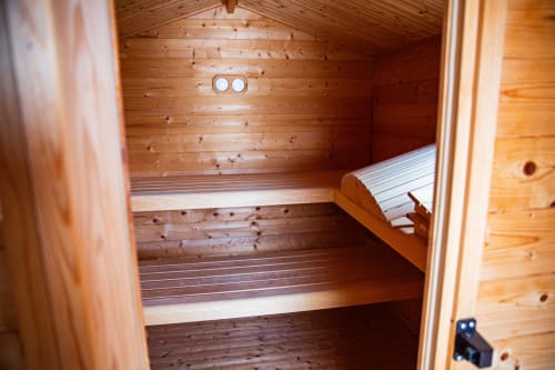 Intérieur de sauna en bois avec bancs à deux niveaux à la Villa Bianca, Mortroux Dalhem