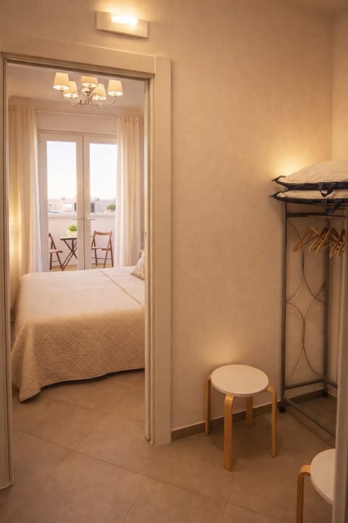 Bright bedroom at B&B Alba in Polignano a Mare with bed, balcony access, and modern amenities