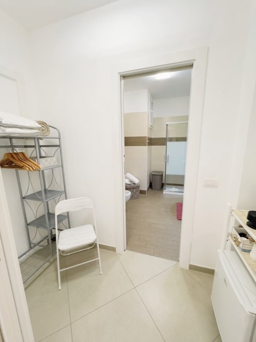 Spacious bedroom in Camera Bea at B&B Alba, Polignano a Mare, with modern furnishings and open door view