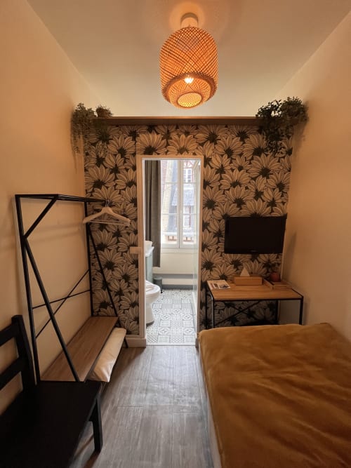 Single room at Hotel Le Trouville with floral wallpaper, desk, TV, and city view in Trouville sur Mer