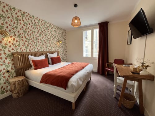 Double bed room at Hotel Le Trouville in Trouville Sur Mer with floral wallpaper, city view, and modern amenities