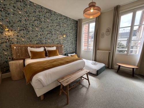 Chambre Supérieure Triple at Hotel Le Trouville with floral wallpaper, wooden bed frame, golden accents, and city views of