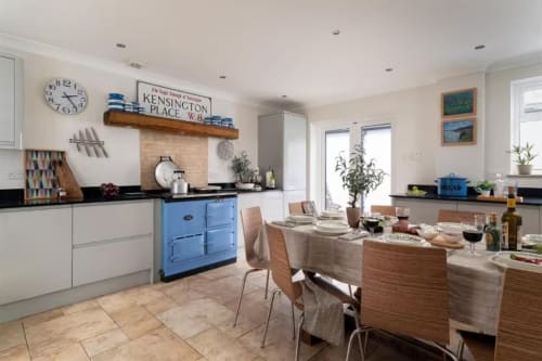 Modern kitchen and dining area at 2 Doves Holiday Property in Exeter with blue Aga stove and wooden table